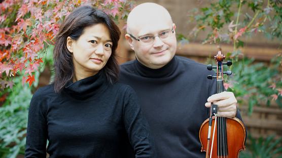 photo of artists together with violin