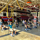 Student firefighters sitting in spaced out chairs.