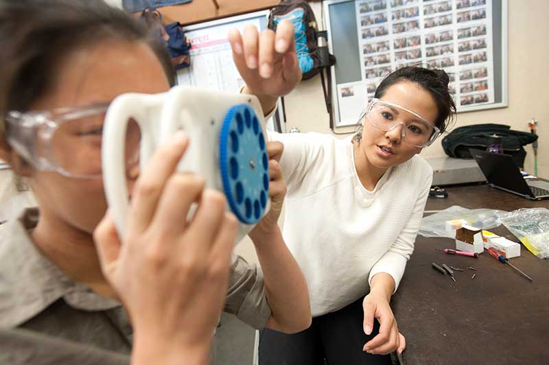 Woman tests view finder being used by another woman