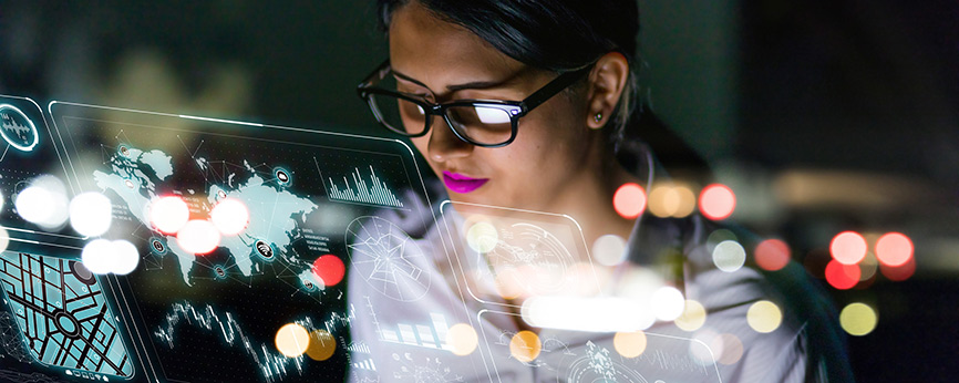 A woman looking at a transparent screen with many images