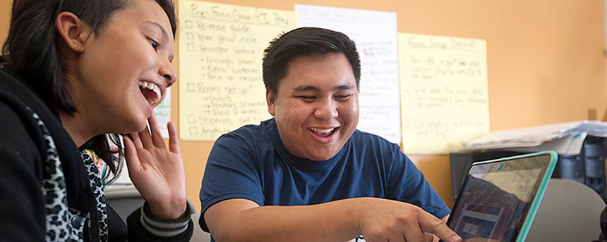 woman and man laughing while working