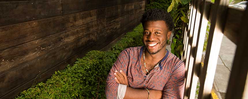 Portrait of a male student in an indoor garden