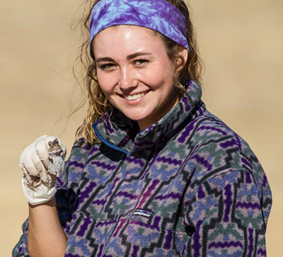 Thalia Badger holding an animal. 