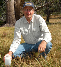 Kenneth Tate in the field with a hat on