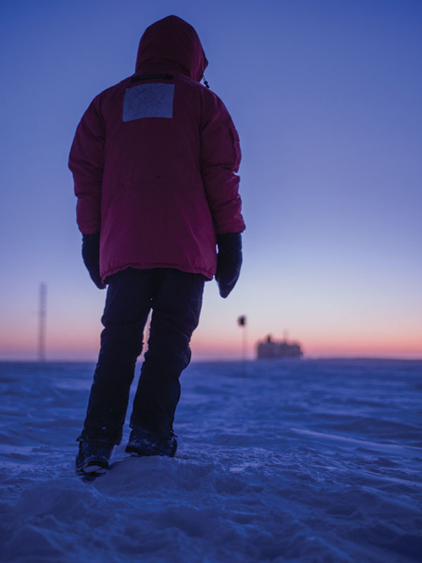 0800 A man stands in the snow at dawn
