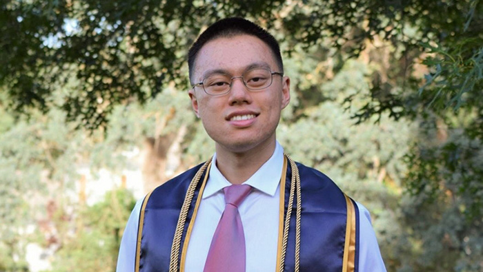 Henry-Low---web UC Davis grad in graduation ribbons
