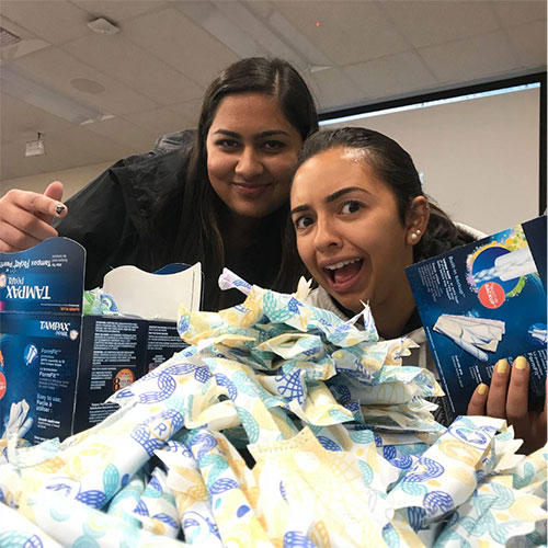 Period-web Sabina Kabra '20 and Anusha Klinder '20 pack period products to send to shelters