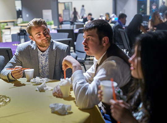 Prom-web-4 Quarterback Brock Johnson, left, talked with guests Natalie Eddy and her boyfriend, Sam Ghilardi.