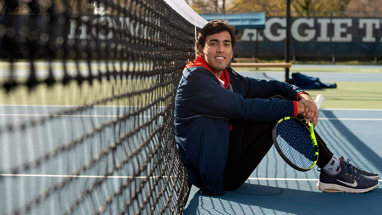 chethan-swanson-full-width Chethan Swanson sits on the tennis court.