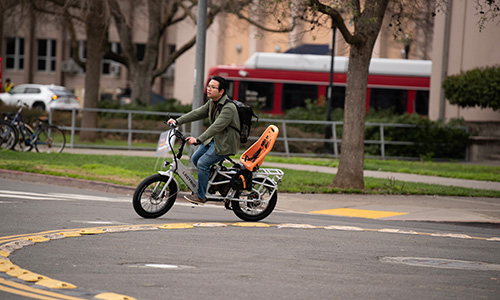 electric-trans-bike Electric bike rider in a traffic circle
