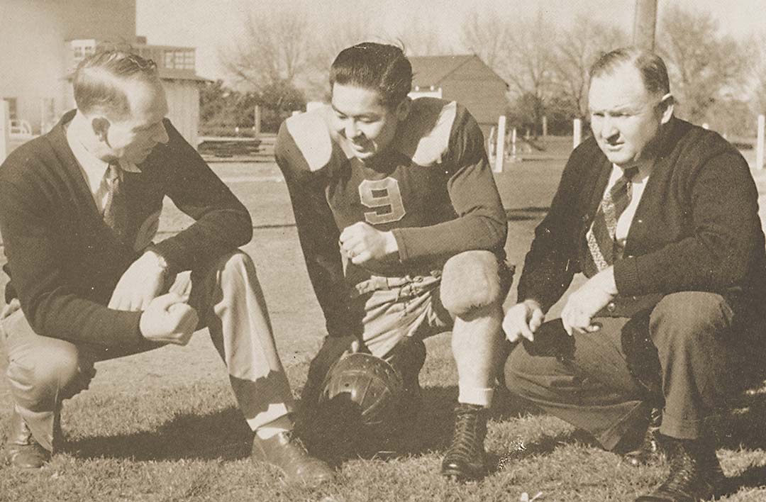 hickey-nitta-woody-uc-davis-football-1939 Two coaches speak with a football player, 1939