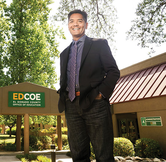 manansala-ed A man stands in front of a school administration building