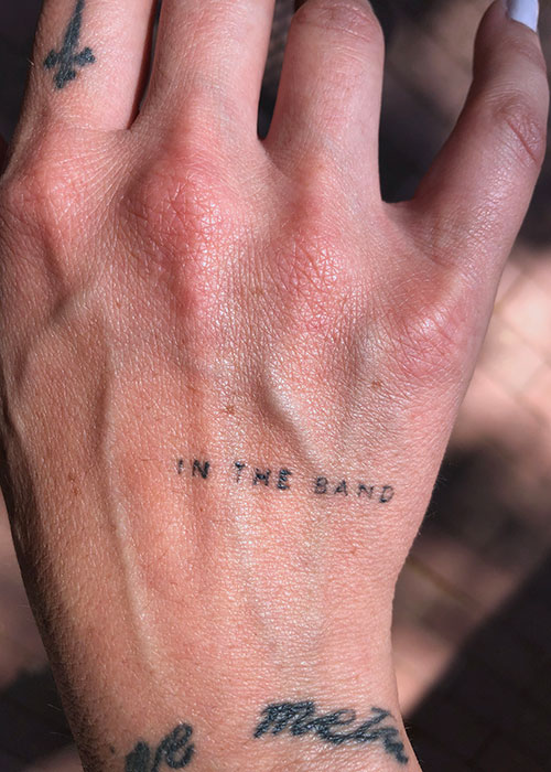 tatoo Jordan Fitch's tattoo that reads "in the band"