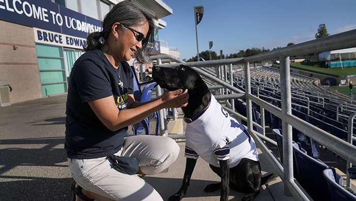 tell-cori Alumna Lisa Tell with dog Cori at the stadium