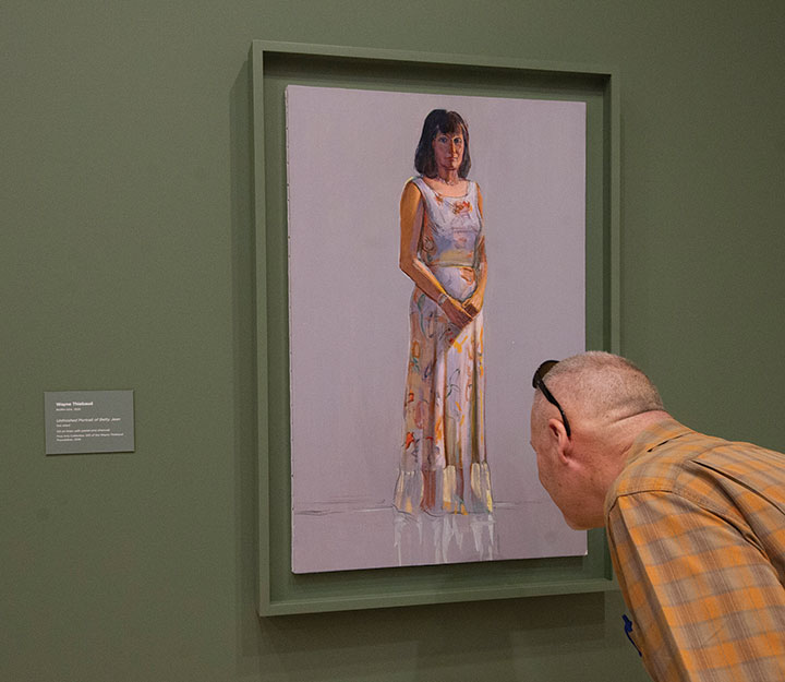 wayne-thiebaud-exhibit-manetti-shrem-museum-uc-davis A museum guest inspects a Wayne Thiebaud painting in an exhibit