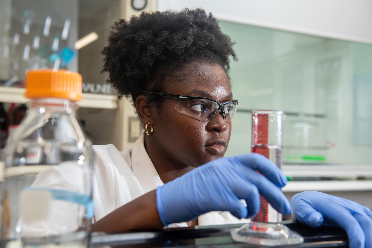 A student looks off into the distance in a biology lab at UC Davis. 