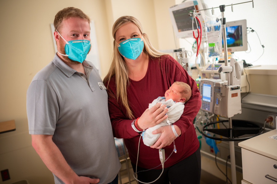 Parents Michelle Johnson and Jeff Maginnis hold baby Tobi Maginnis in hospital.