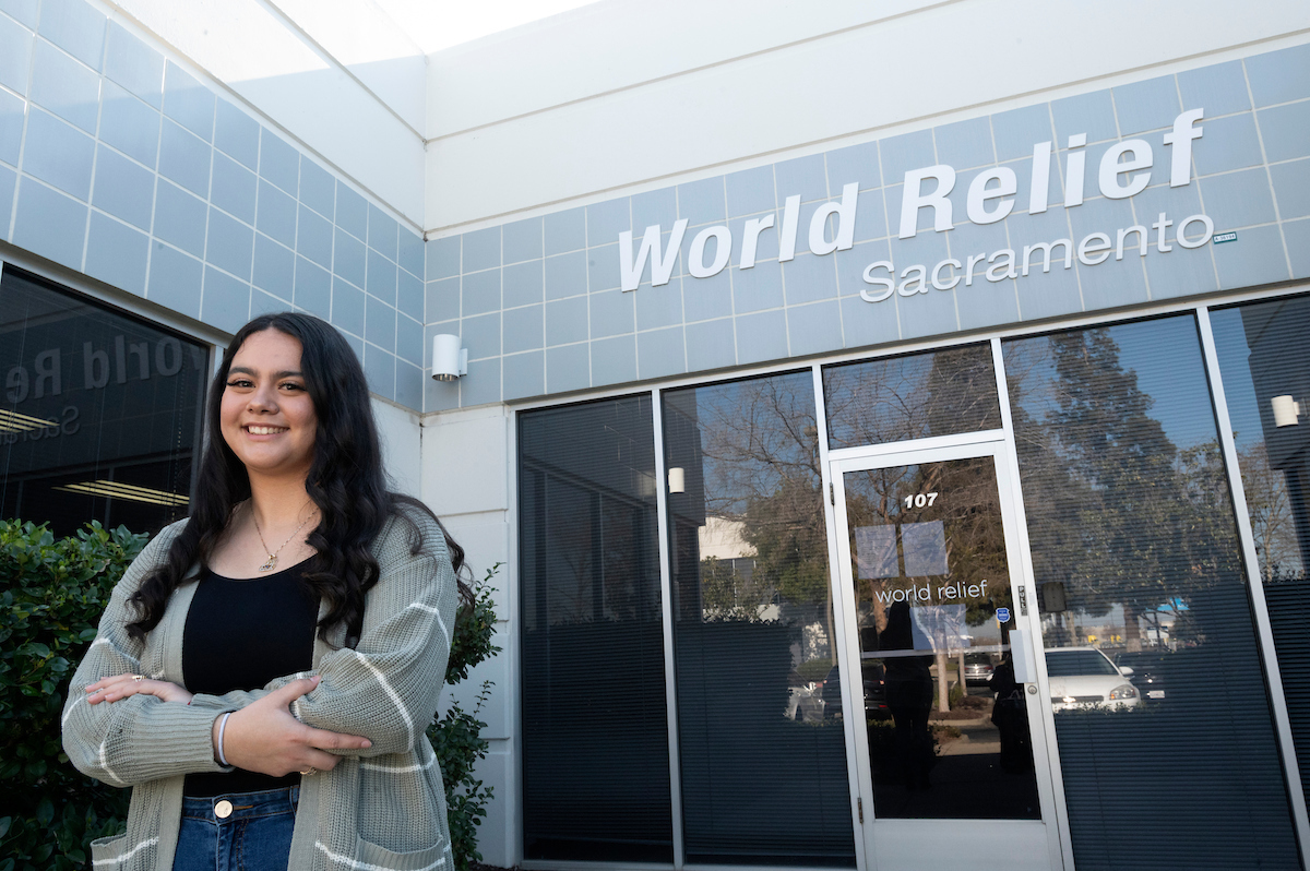 A UC Davis student poses outside her internship office.
