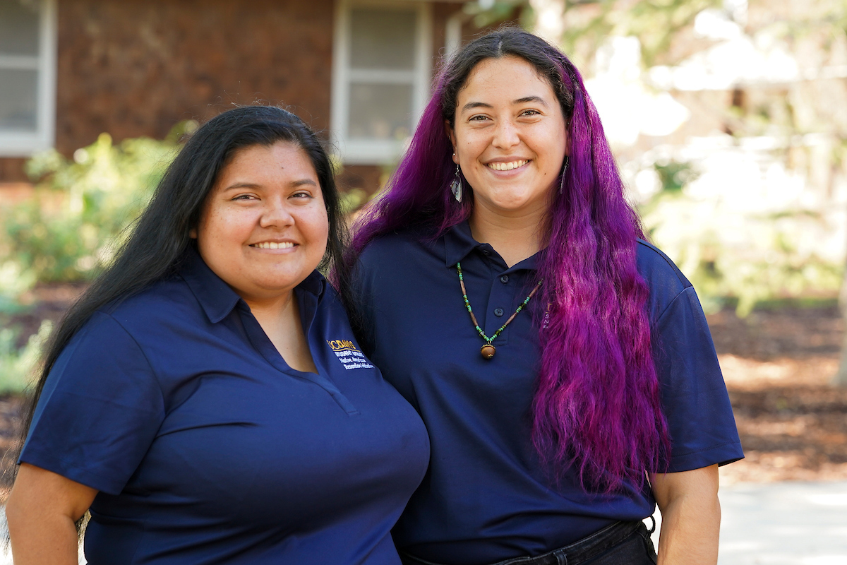 Two students smile on campus at UC Davis.