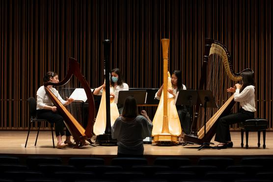 Students playing instruments on stage