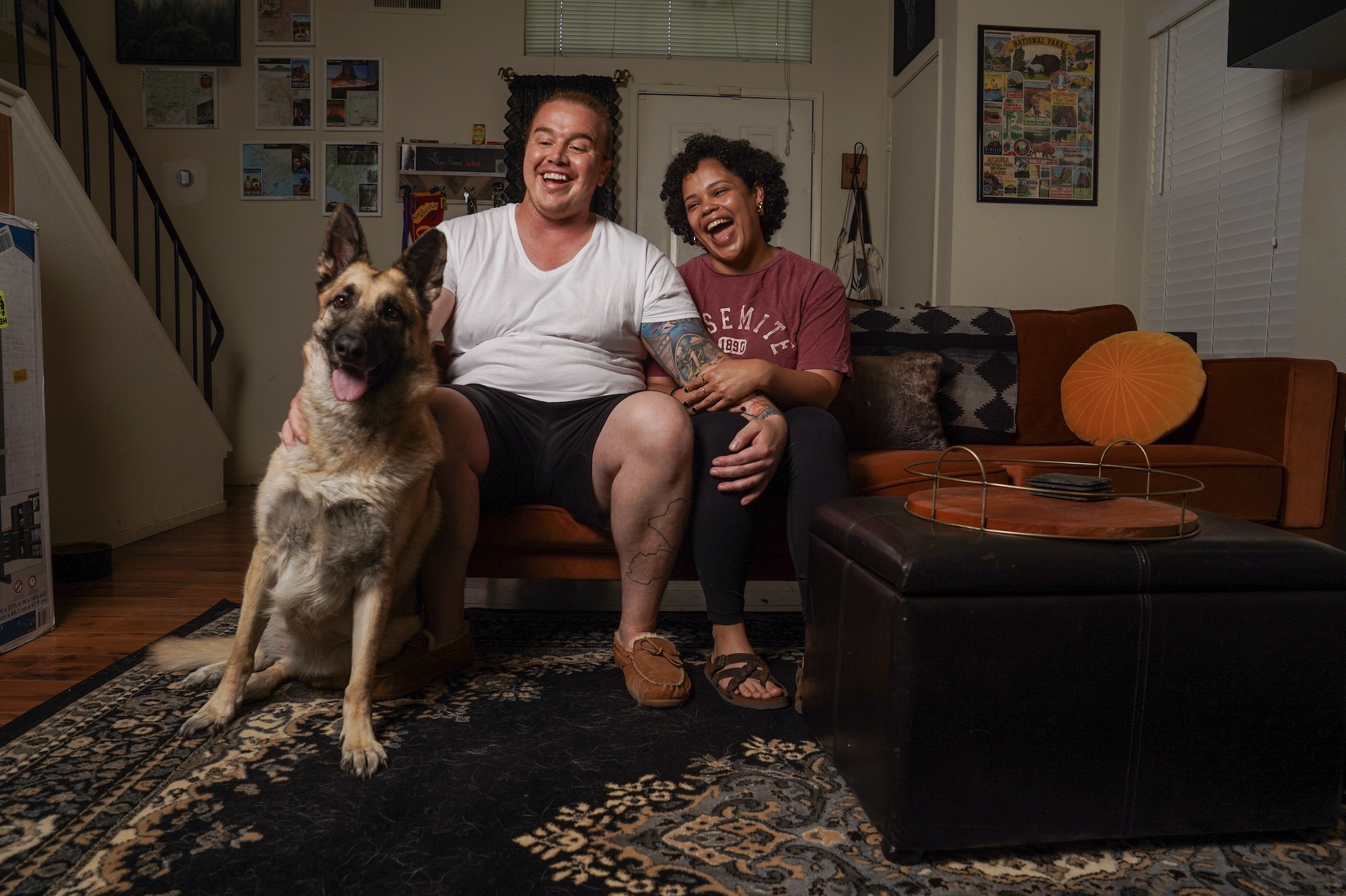Matthew Treviño, Emily Fletcher and their dog Rosie, a german shepherd mix, sit on a couch at their home in Sacramento. Matthew is part of a UC Davis Health clinical trial for a hormonal birth control gel for men.