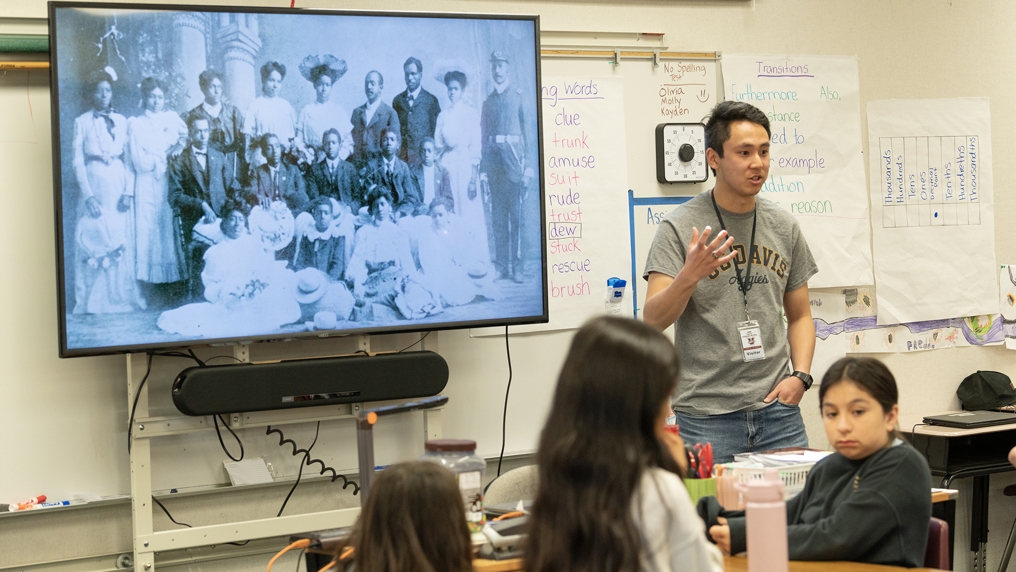 teacher in a classroom showing a presentation