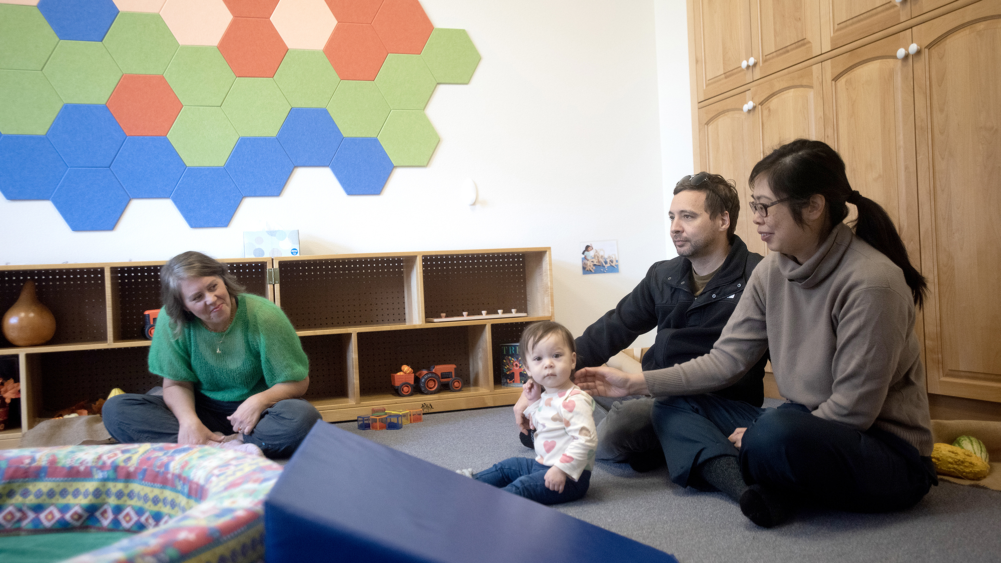 parents with a baby and a teacher