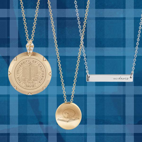 UC Davis branded jewelry is depicted in front of an Aggie Blue backdrop.