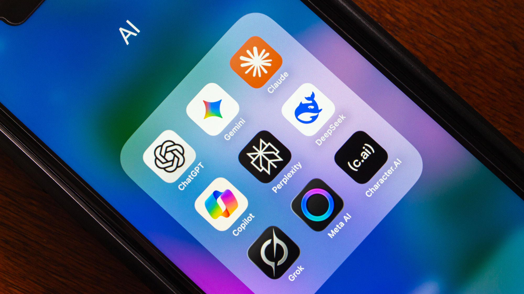 Phone screen with open app folder of colorful icons on gradient wallpaper