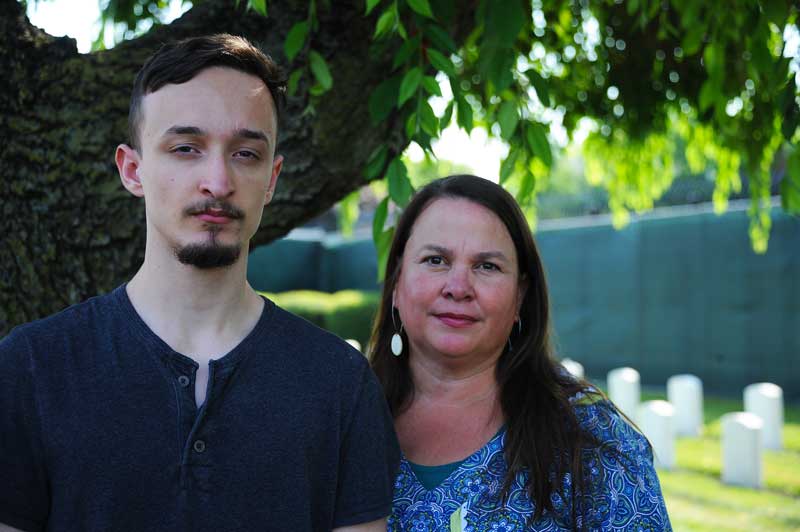 man and woman with cemetery in background