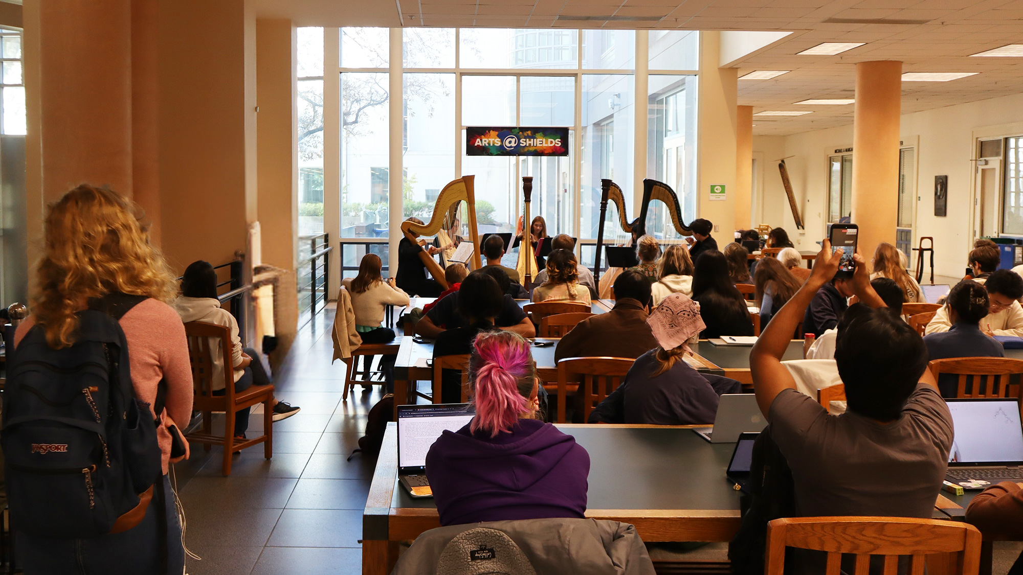 Students attend a harps performance inside the UC Davis Library