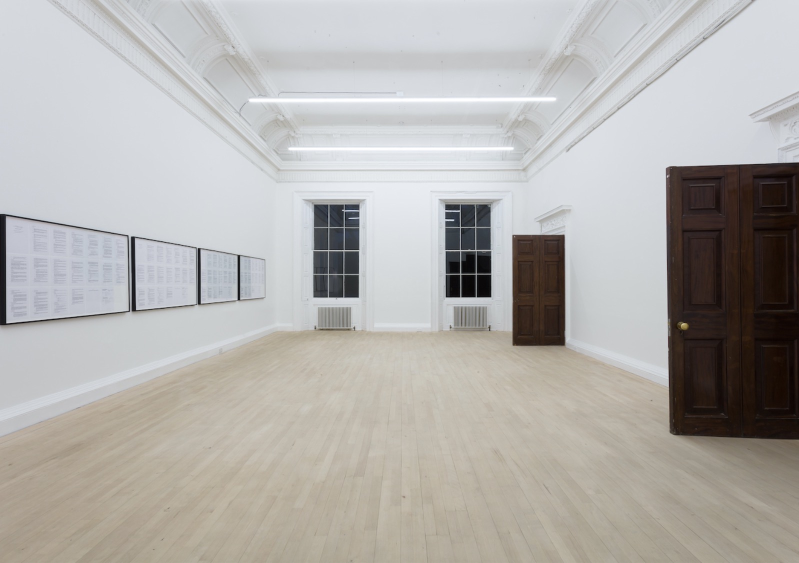 Shot of long hall with art on walls.