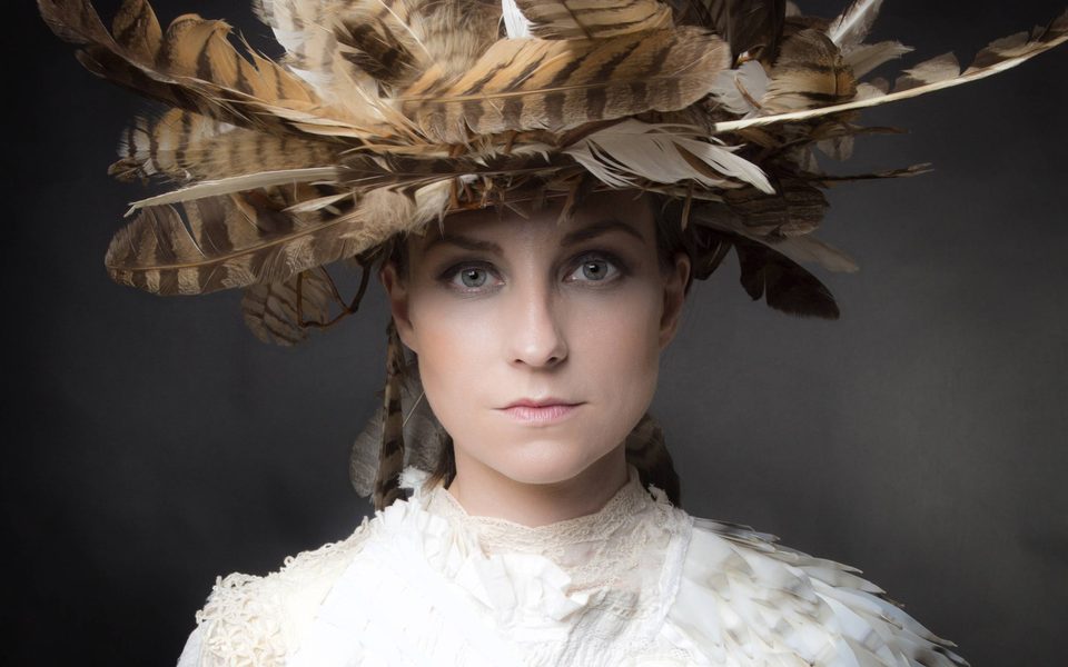 Portrait of woman wearing a plumed hat