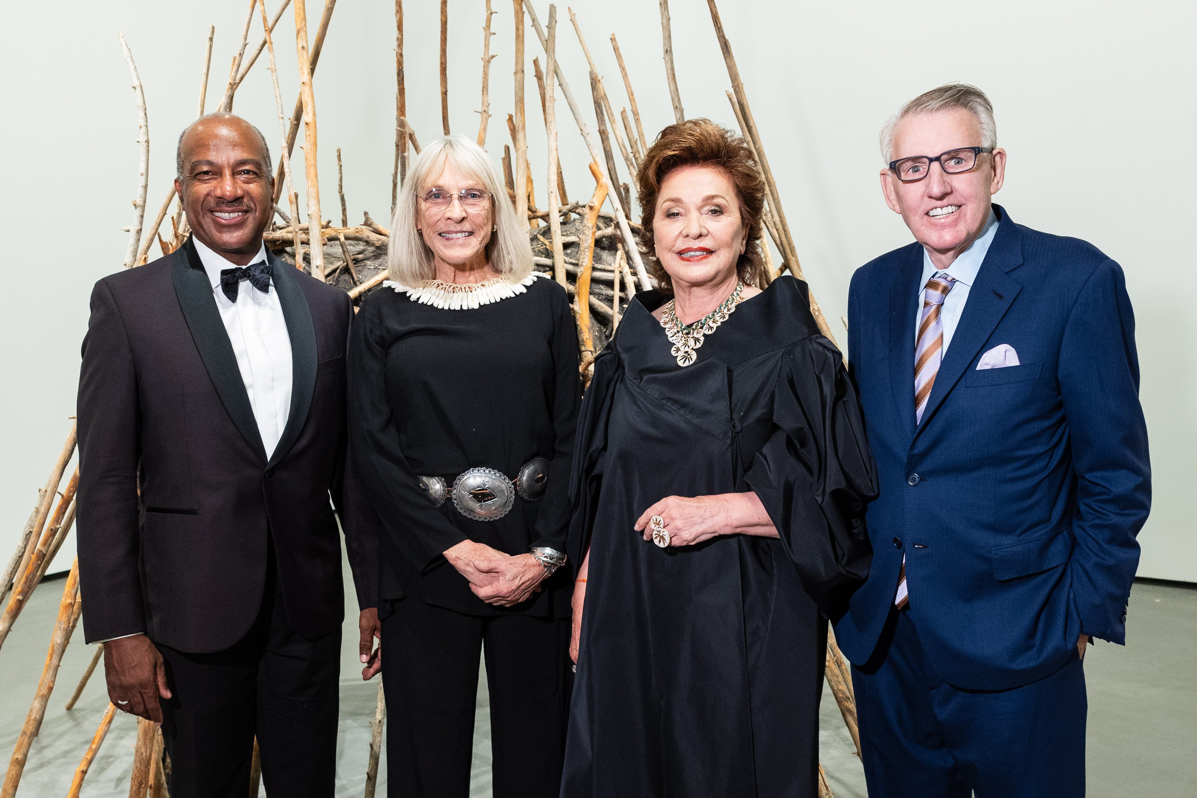 Four people in formal wear at event