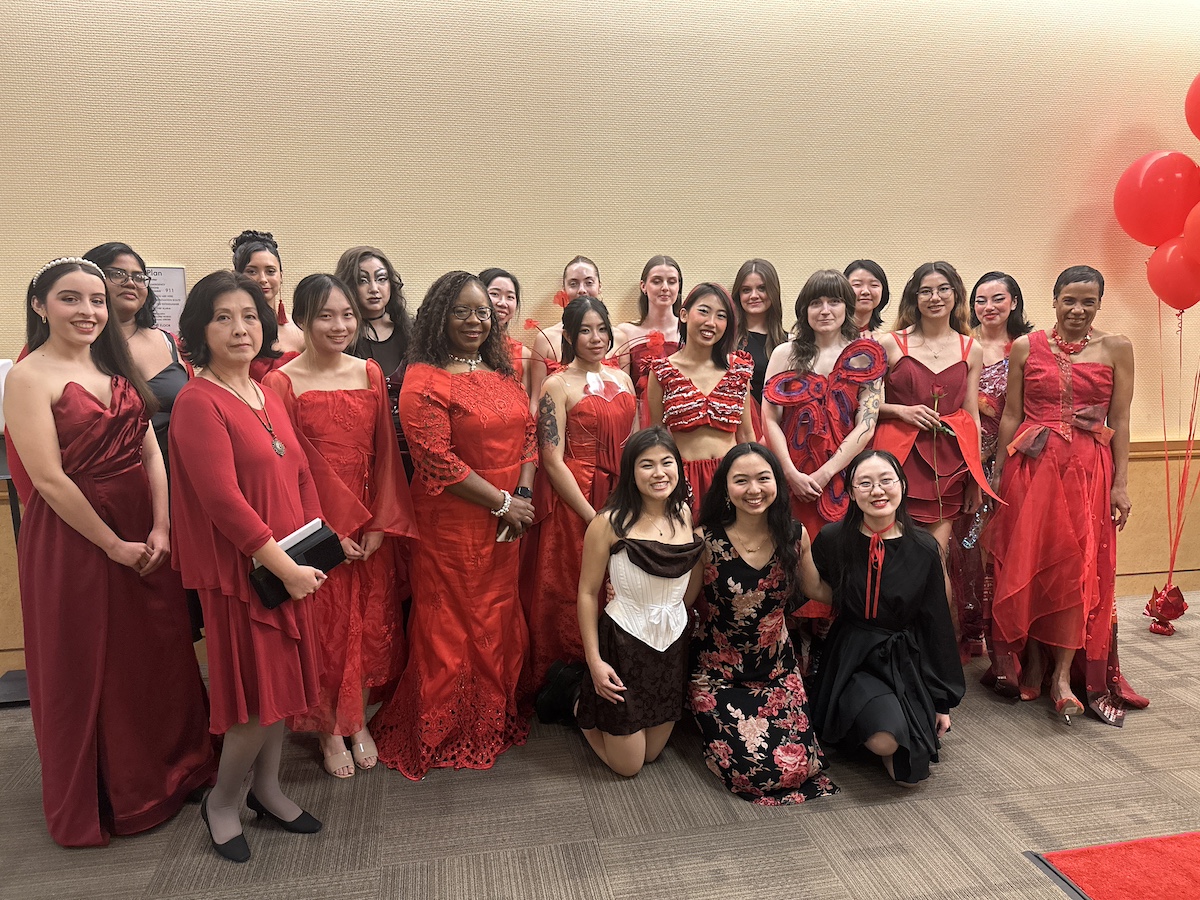 Adele Zhang (second to left), Estella Atekwana (fourth to left) and LeShelle May (far right) posed with student desingers and models who participated in the UC Davis Red Dress Collection fashion show in 2024.(Tracy Sellers/ UC Davis)