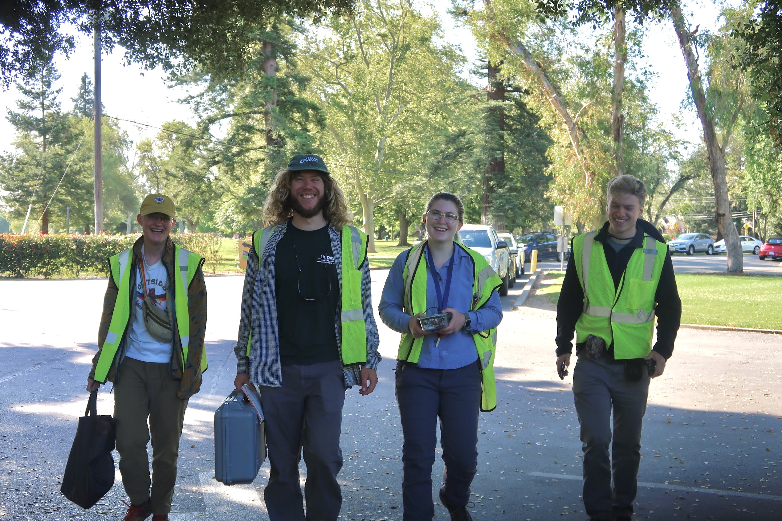 Andrew Bousfield (Left), Ian Haliburton, Sage Madden, and Jacob Johnson (Right) walking forward with gear