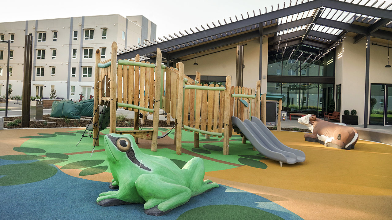 A frog and a cow play sculpture in the Orchard Park playground