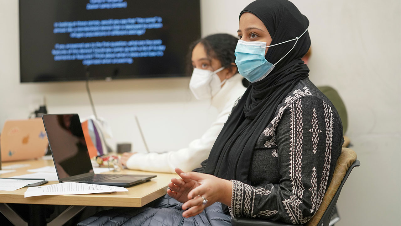 A woman participates in a classroom discussion