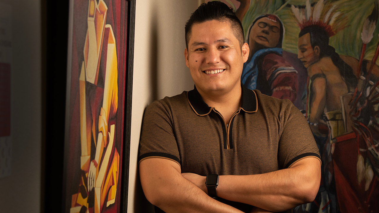 Rodrigo Bonilla stands amid artwork.