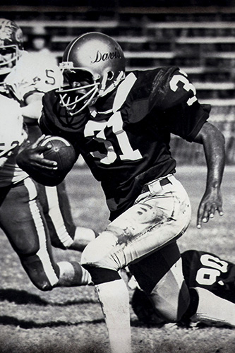 Ron Austin rushes with the football in a game from his time as an Aggie