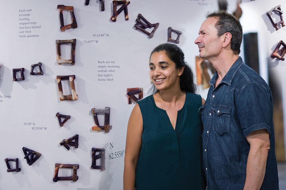 Woman and man in front of exhibit wall