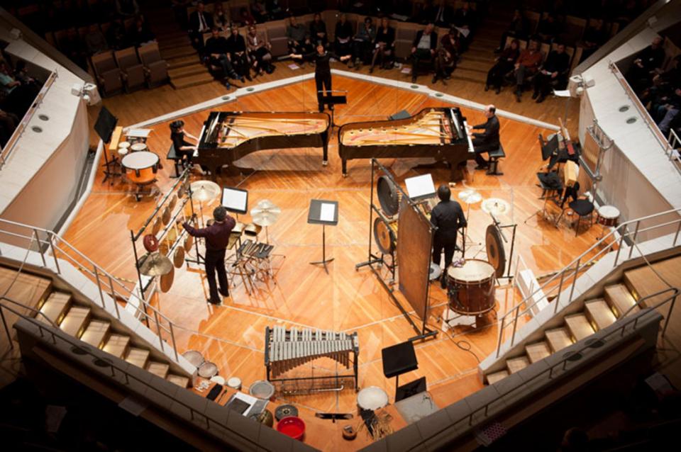 Band performers on a stage photographed from overhead. 