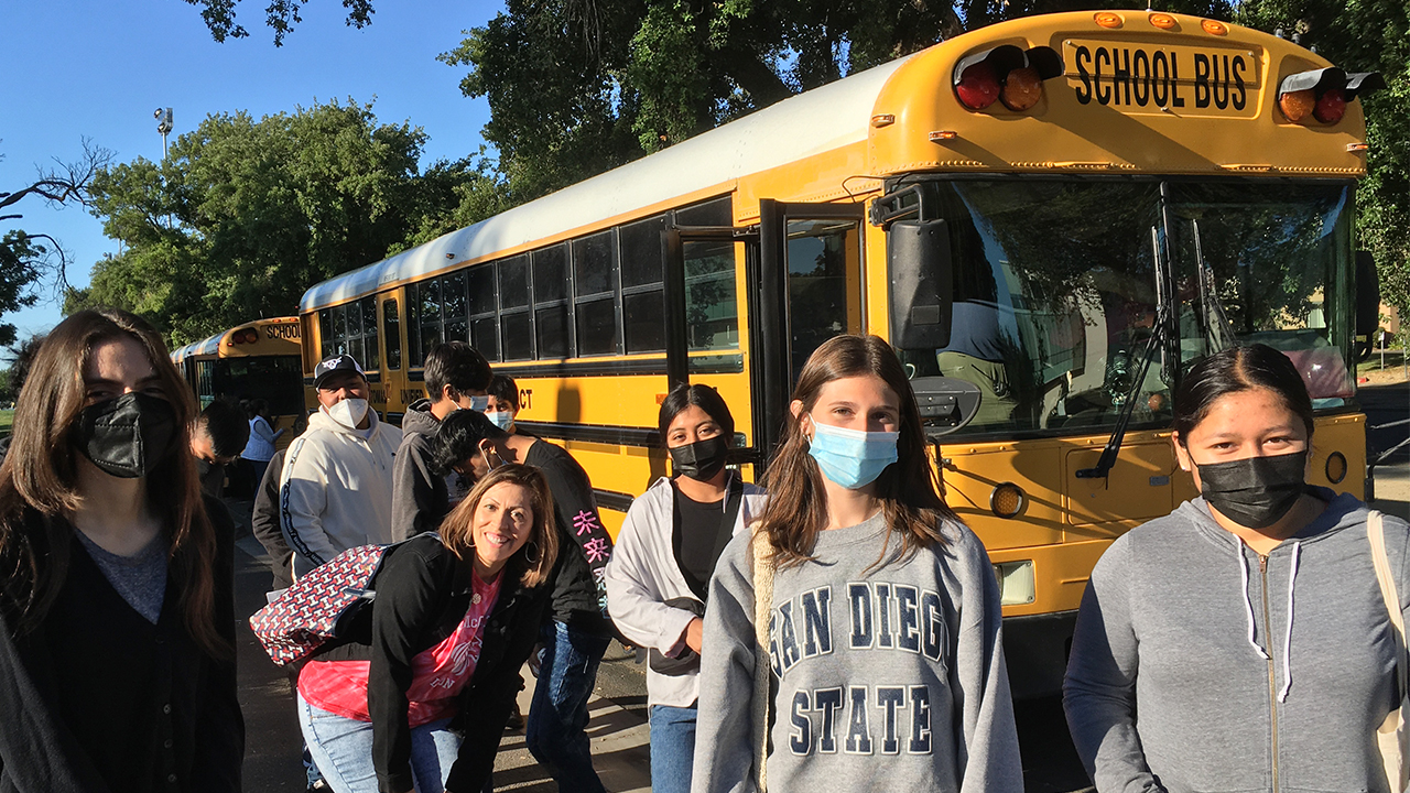 Students getting off school buses