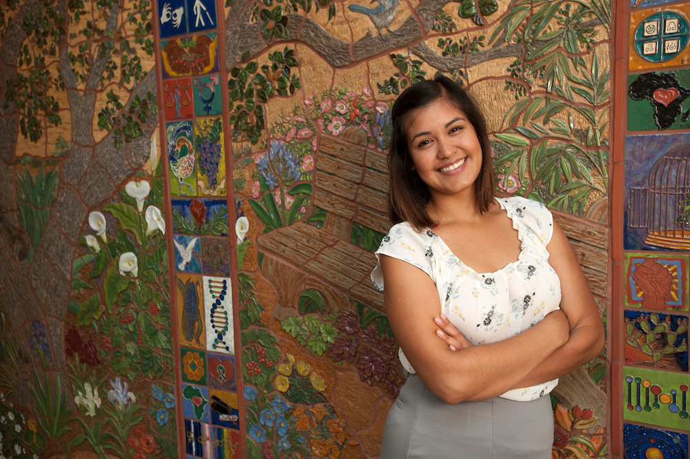 Valeria Garcia, a community development graduate studies major, stands in front of a mural in the Student Community Center on Friday August 8, 2014 at UC Davis.