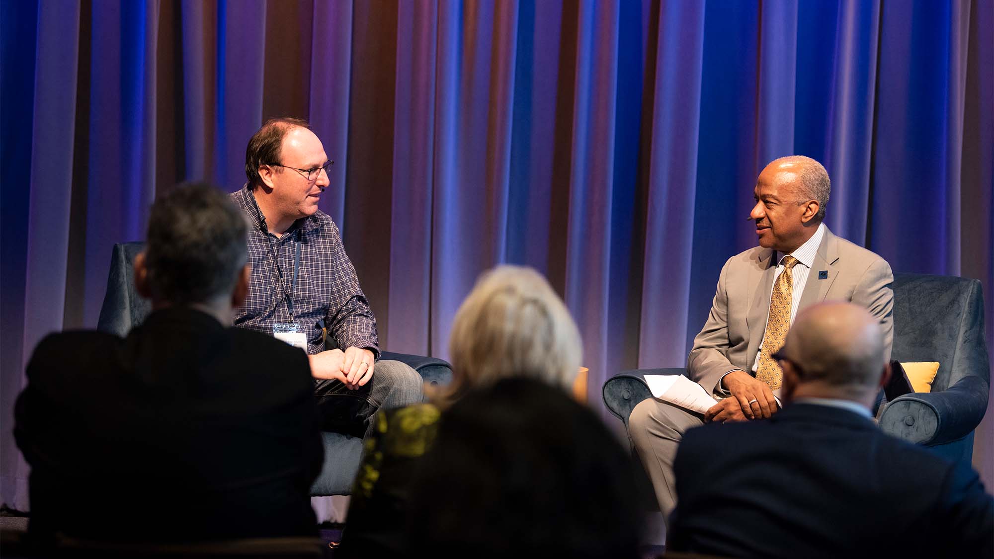 Chancellor Gary S. May and Justin Siegel talk on stage