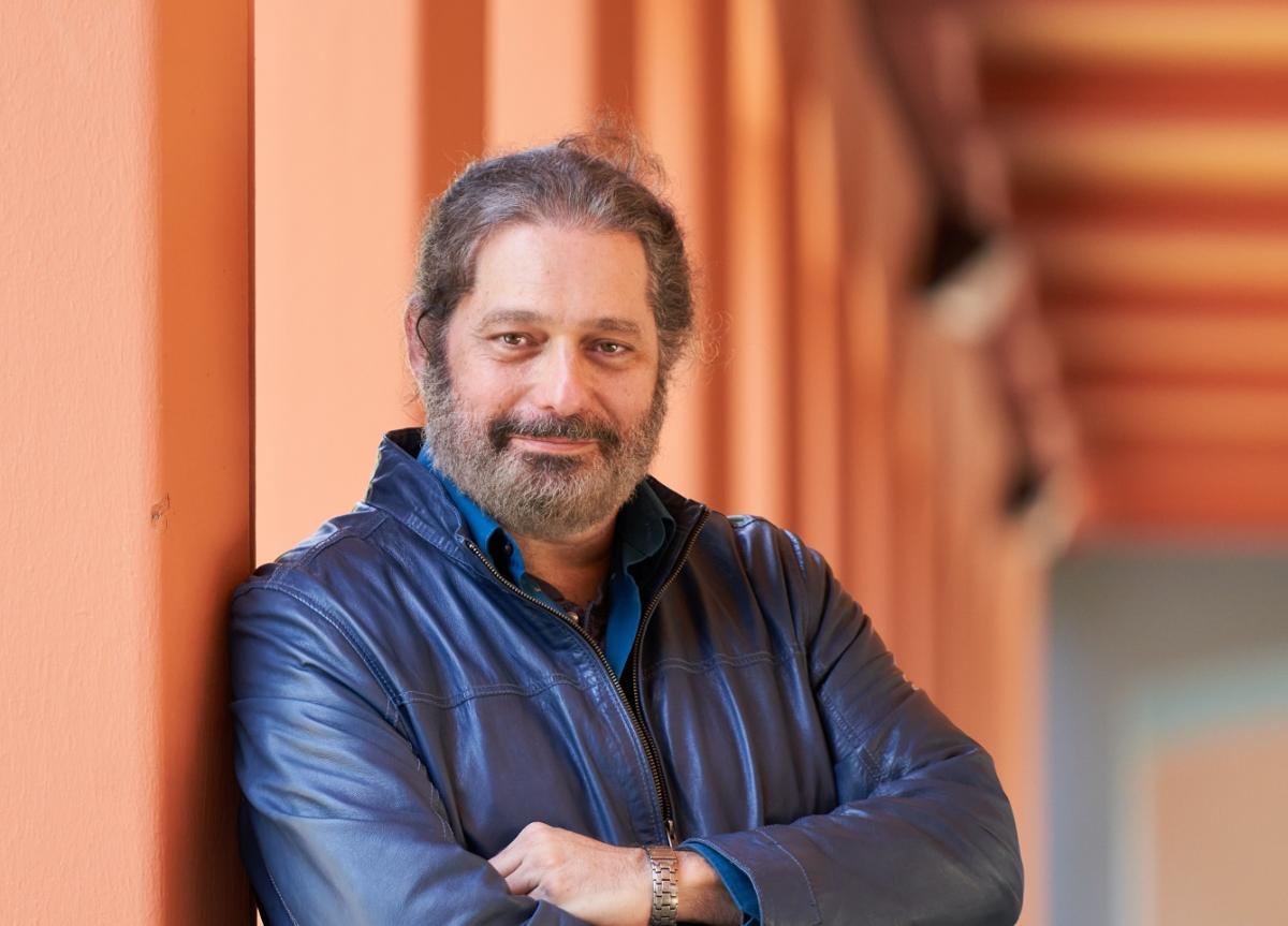 Man with beard in front of orange backdrop