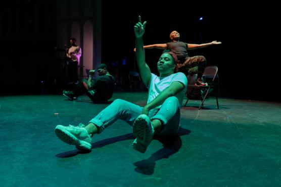 Man dancing on floor in dark theater or concert stage