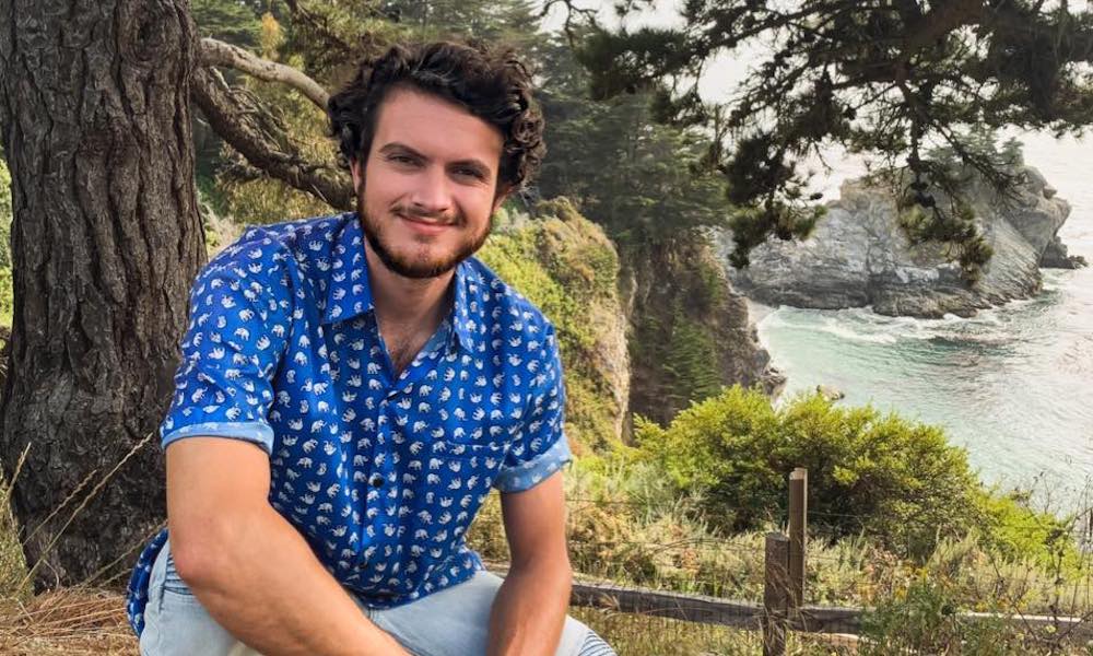 Erik poses in front of a cliff, he's an education minor at UC Davis.