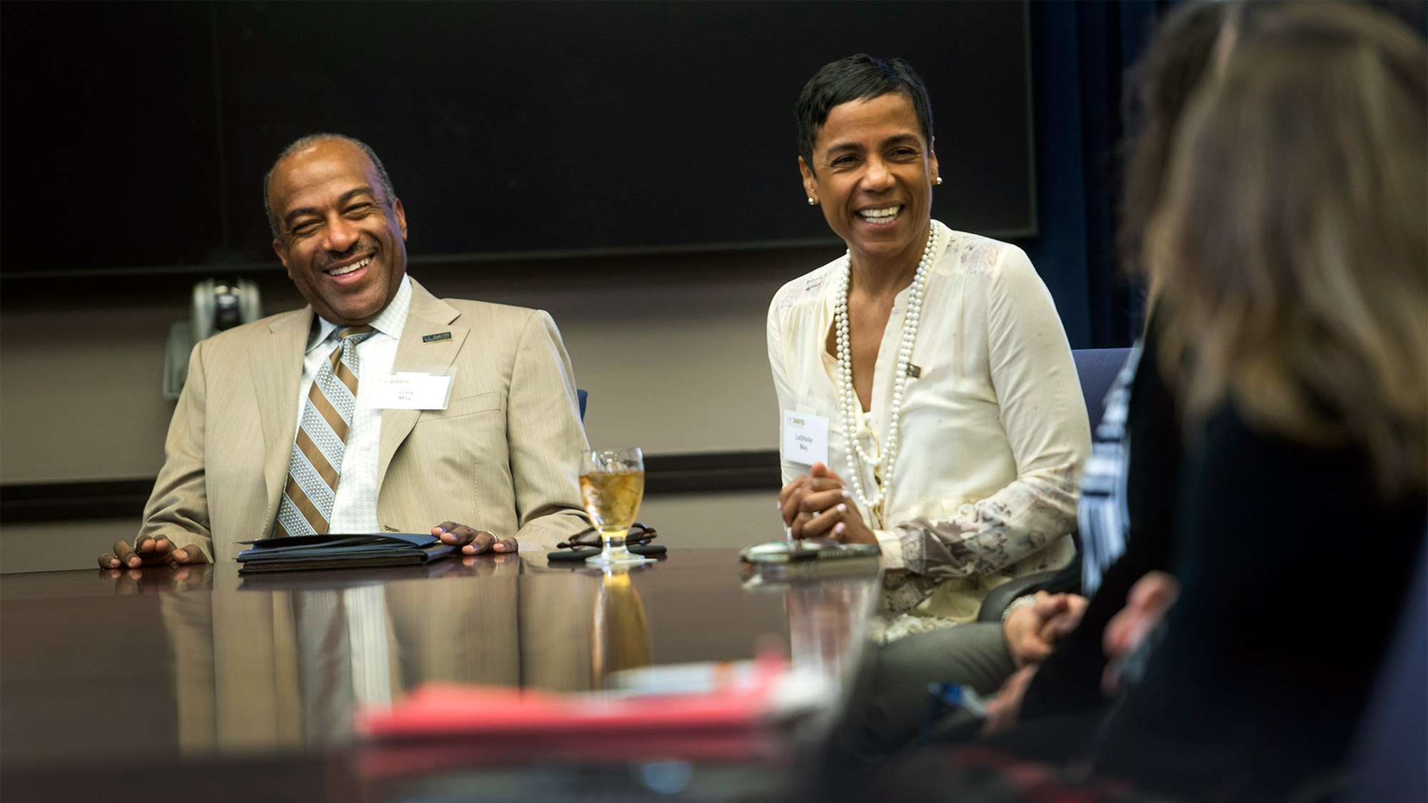 Gary S. May and LeShelle May at a meeting table.