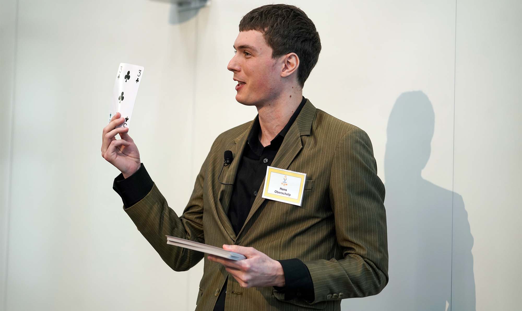 Student holds up oversized playing card.